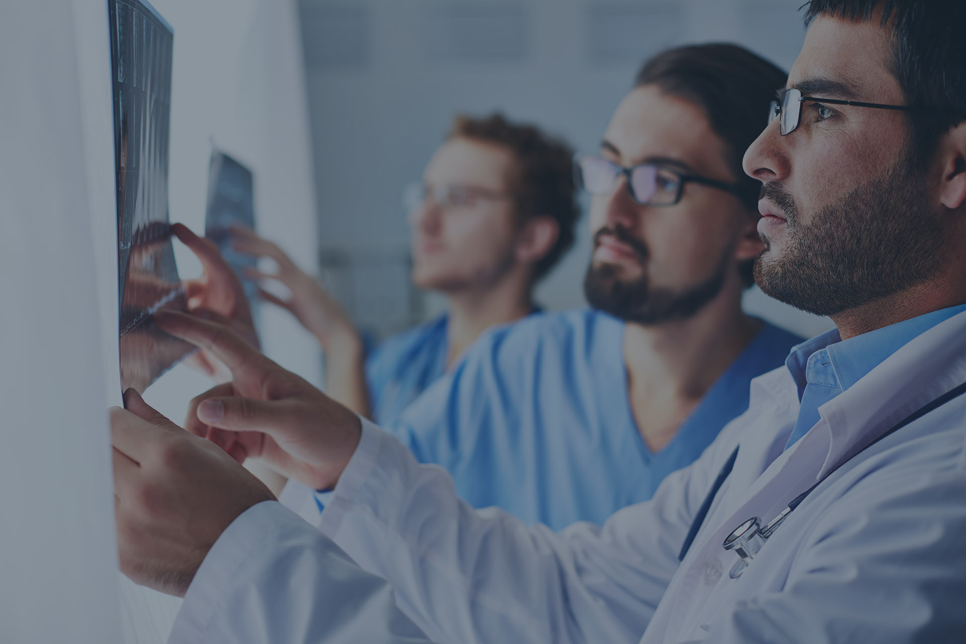 Portrait of young male doctors looking at x-ray